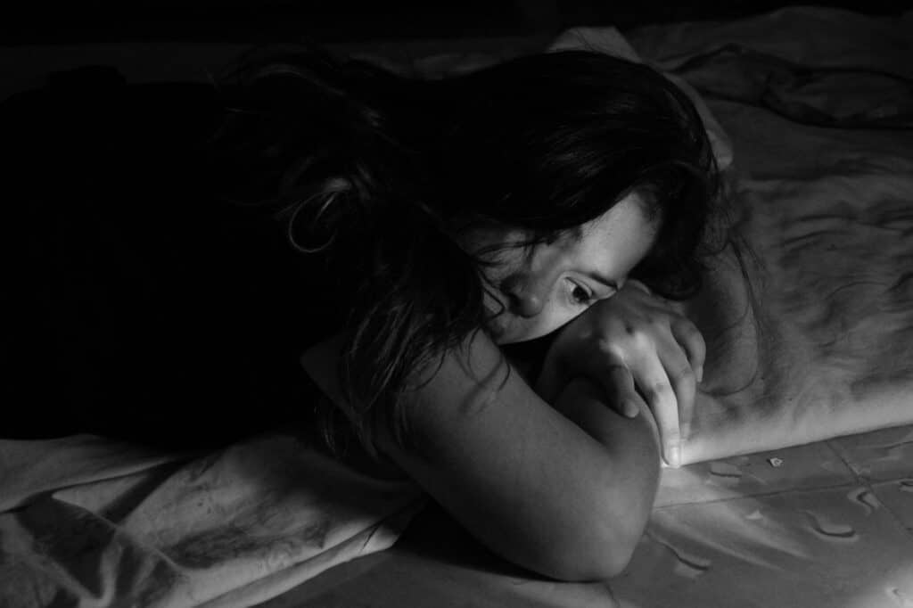 woman with hormonal imbalance lying in bed