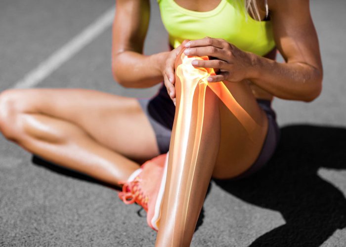 Low,Section,Of,Sportswoman,Suffering,From,Knee,Pain,While,Sitting