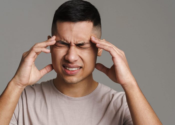 Displeased,Handsome,Guy,With,Headache,Rubbing,His,Temples,Isolated,Over